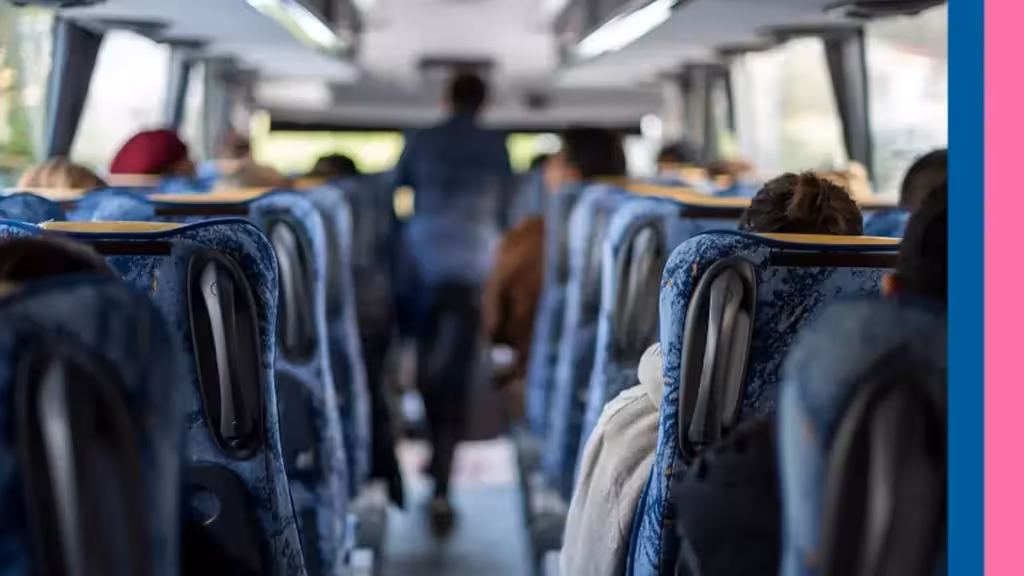 Illustrative image of a bus interior with seated passengers and a central aisle
